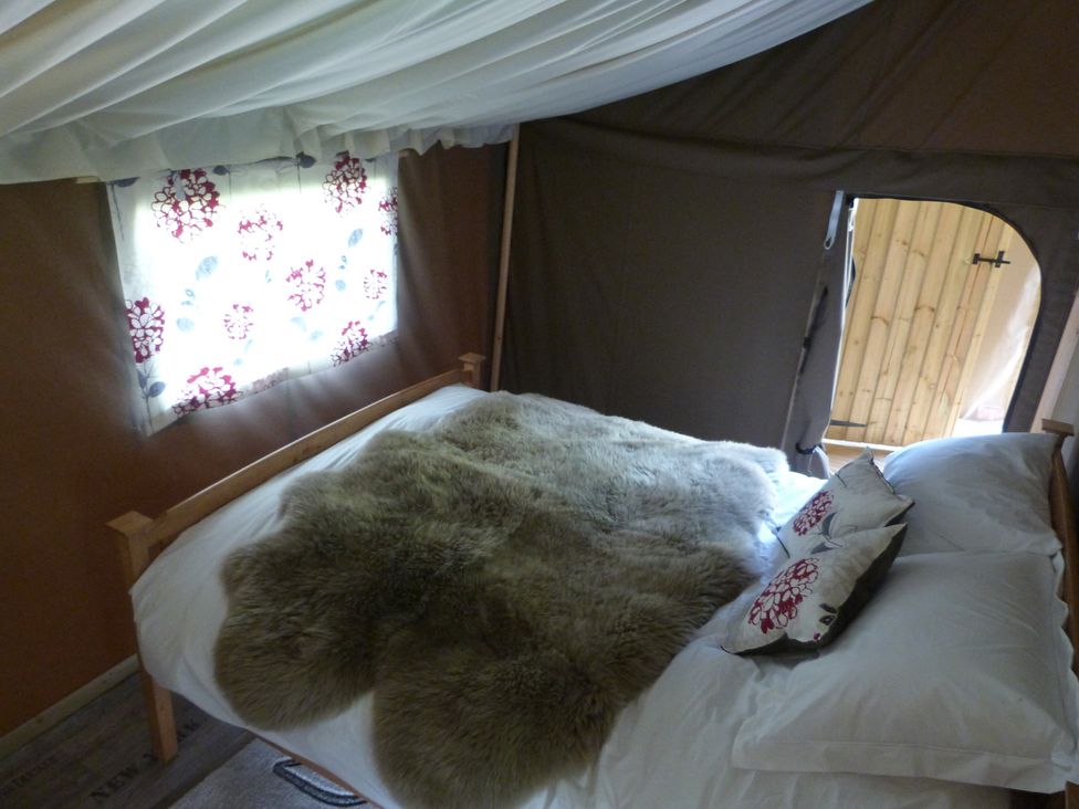 A bedroom with a bed and window at Ceri Newcastle Emlyn