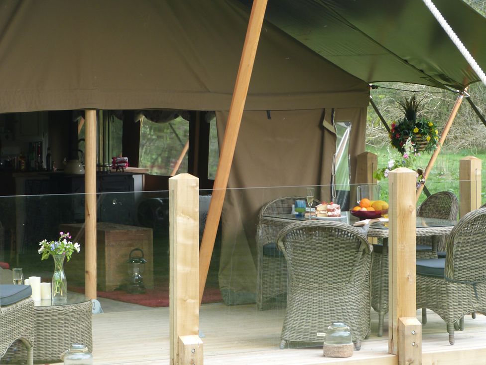 An outdoor dining area with a table and chairs at Ceri in Newcastle Emlyn