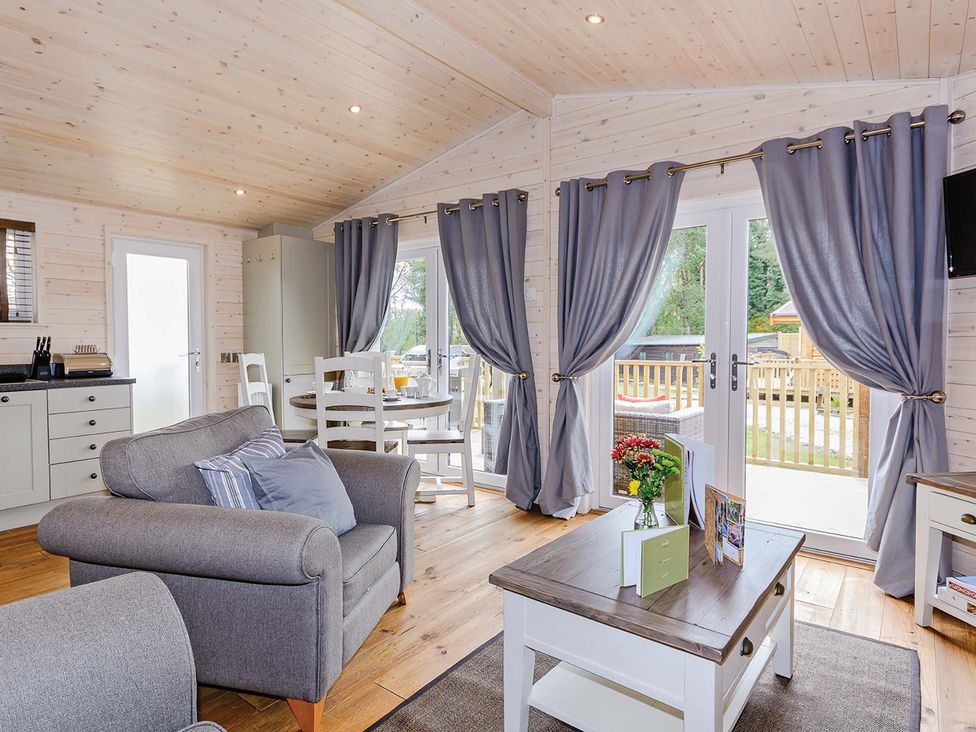 A living room with a sofa and table at Typhoon Lodge in Winchester