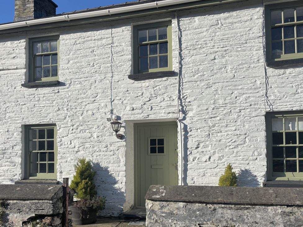 A house exterior with windows and a door at Millers Cottage in Newcastle Emlyn
