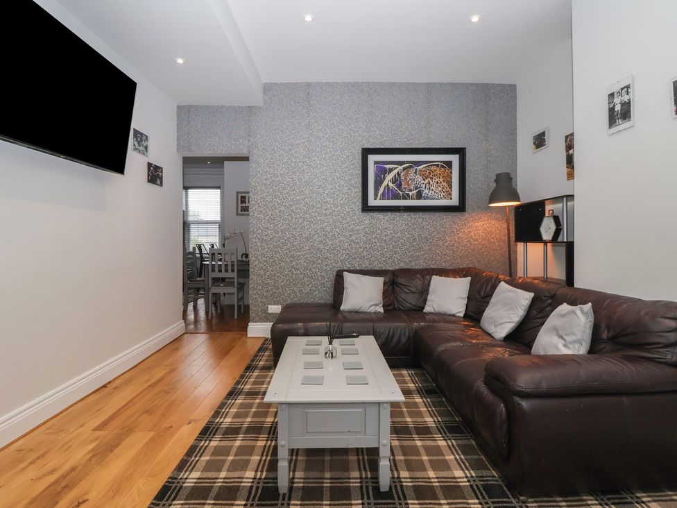 A living room with a sofa coffee table and television at Flat 2 23 Hyde Park Road Harrogate