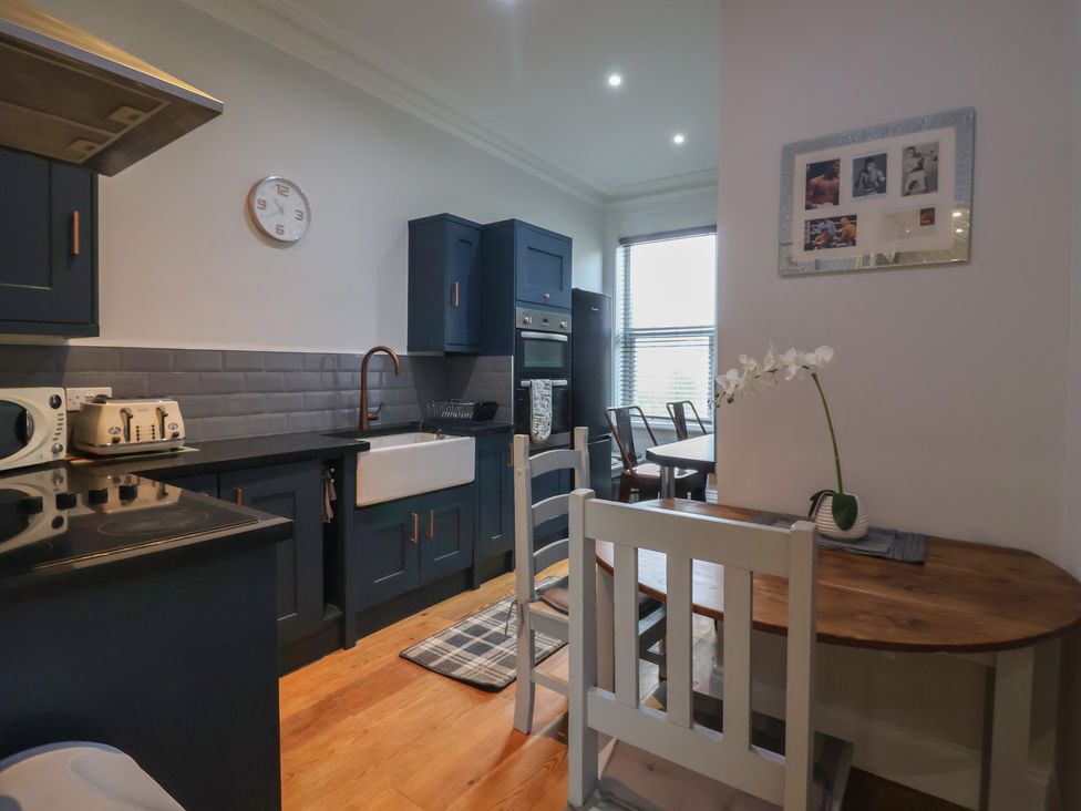 A kitchen with furniture and appliances at Flat 2 23 Hyde Park Road Harrogate