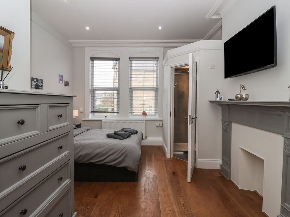 A bedroom with a bed and a television at Flat 2 23 Hyde Park Road Harrogate