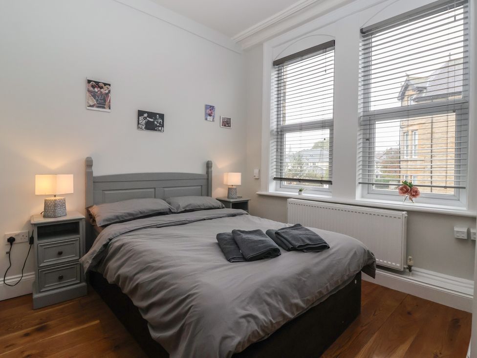 A bedroom with a bed and bedside tables at Flat 2 23 Hyde Park Road Harrogate
