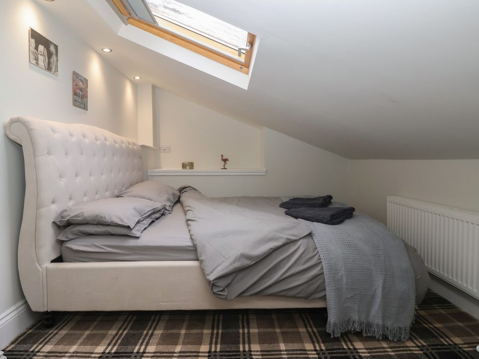 A bedroom with a bed and decorative elements at Flat 2 23 Hyde Park Road, Harrogate