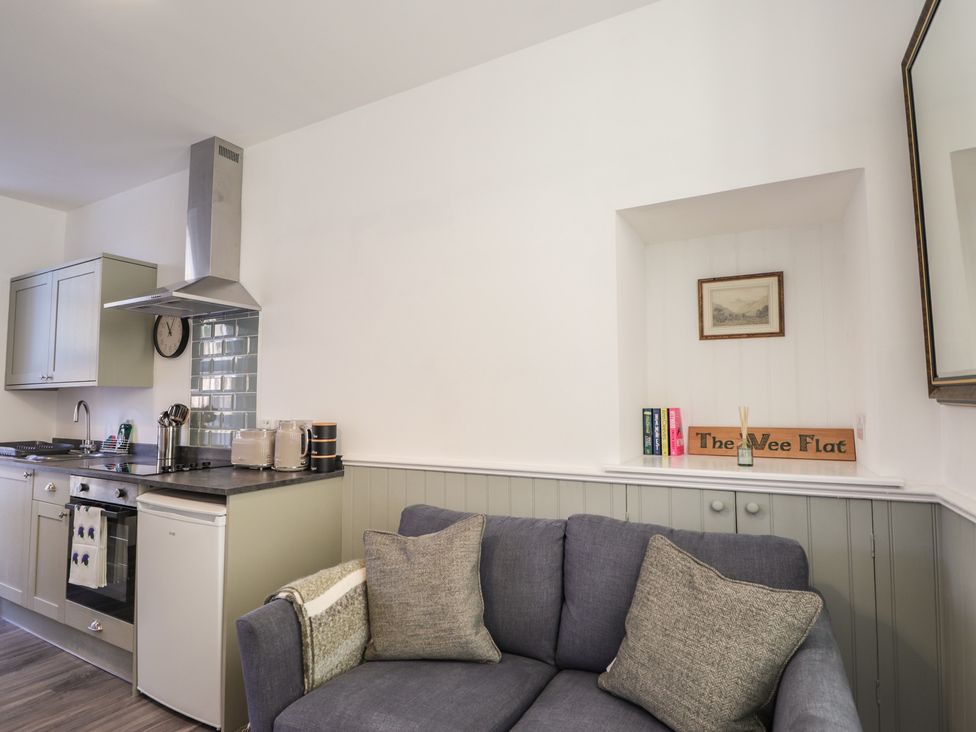 A kitchen with stove and refrigerator at The Wee Flat in Avoch