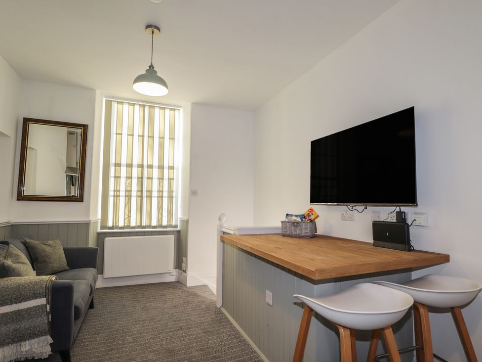 A living room with a sofa and tv at Wee Flat in Avoch