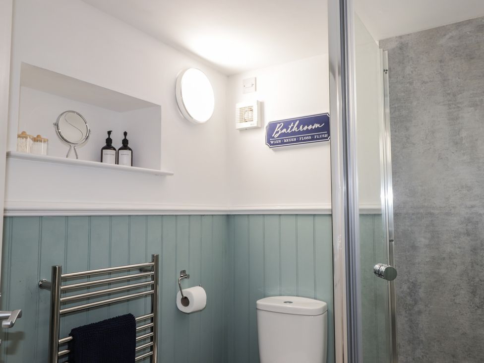 A bathroom with a shower and a toilet at Wee Flat Avoch