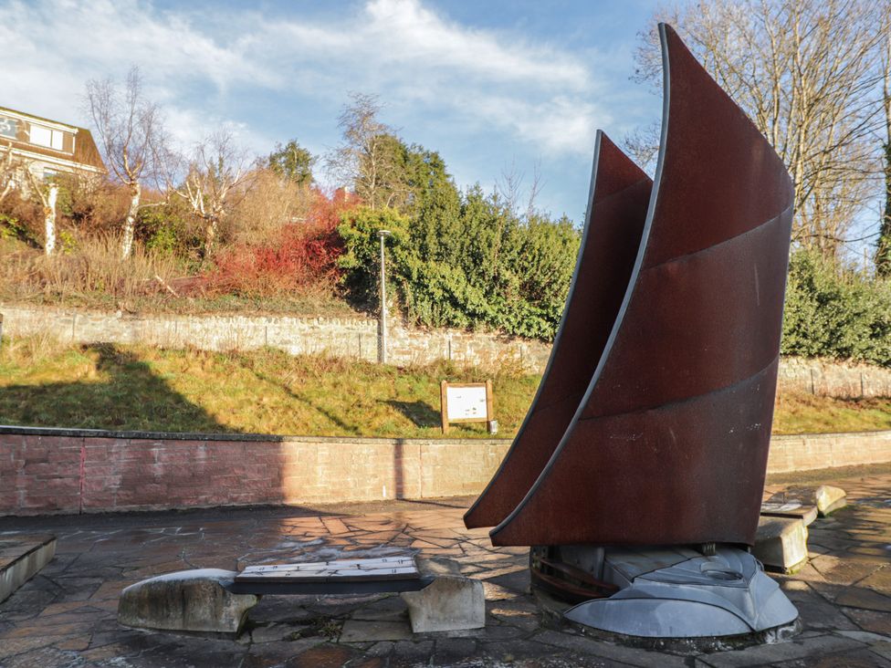 A sculpture on a pathway near grass and trees at Wee Flat in Avoch