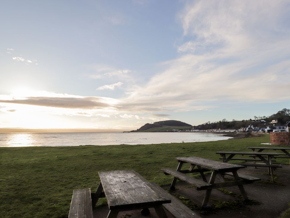 A view of picnic tables by the sea at Wee Flat in Avoch