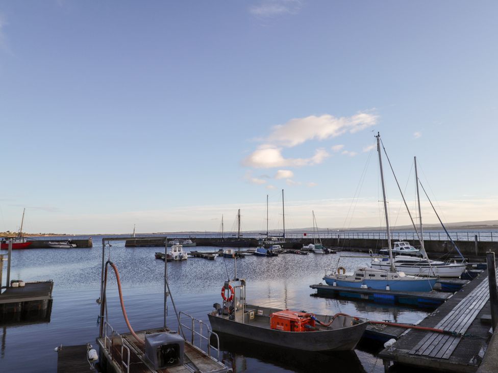 A marina with several boats and water at Wee Flat in Avoch
