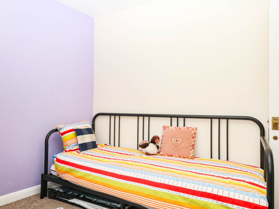 A bedroom with a bed and pillows at The Gables in Teignmouth