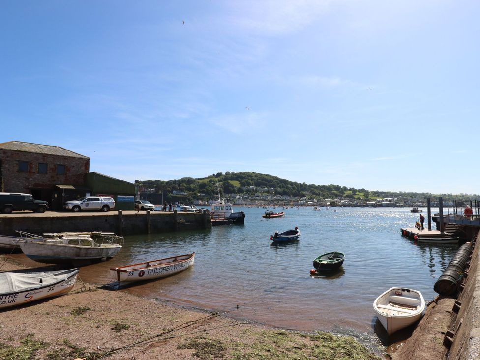 A view of a harbor with boats and buildings at The Gables in Teignmouth