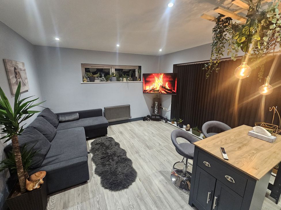 A living room with a sofa and television at Cosy Southampton Apartment in Southampton