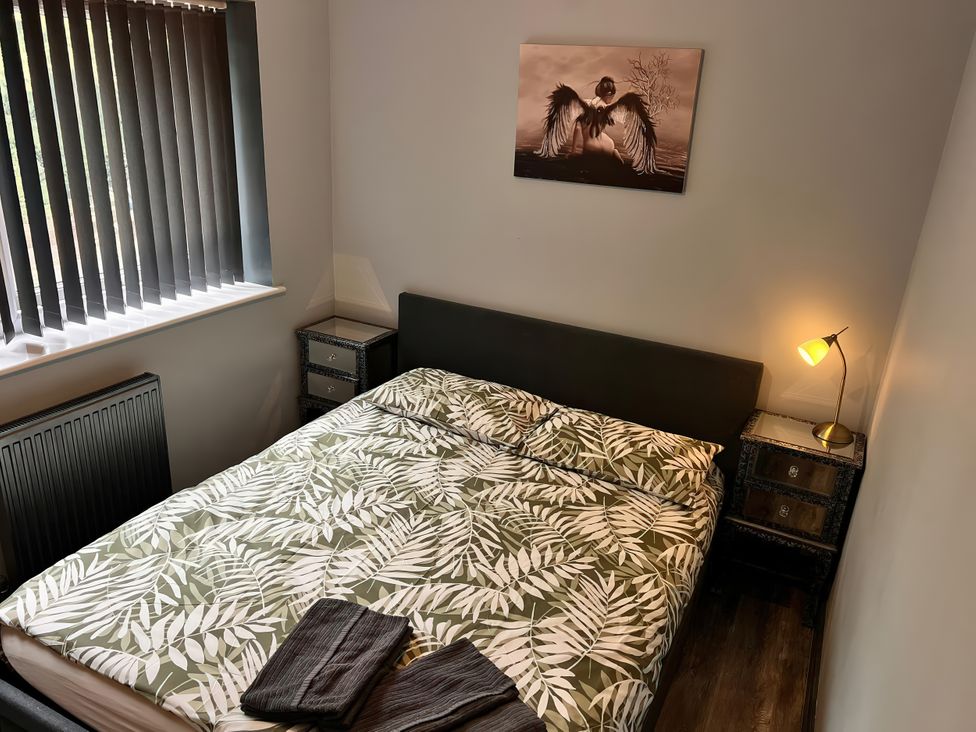 A bedroom with a bed and bedside table at Cosy Southampton Apartment in Southampton