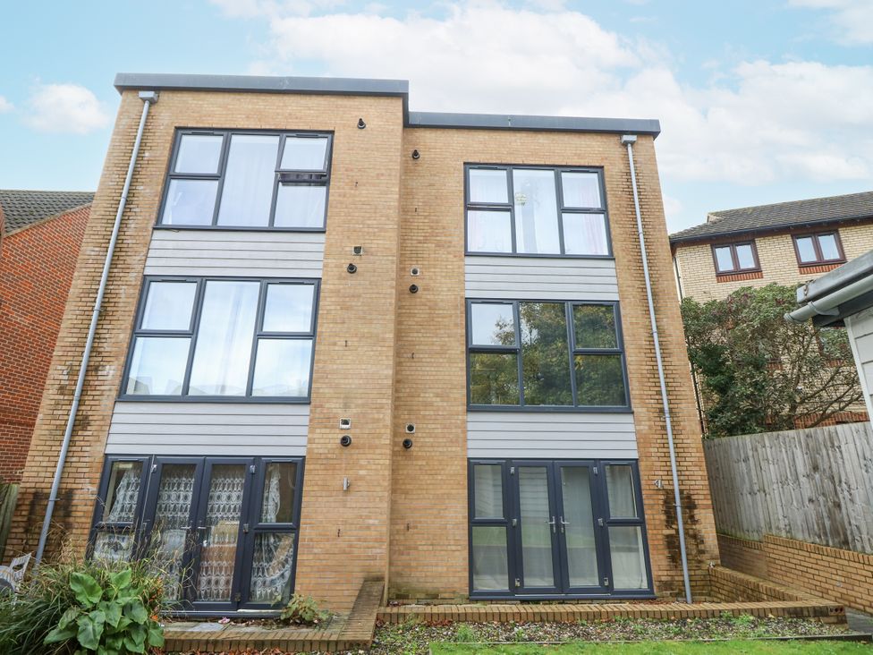 A two-story building with windows and doors at Cosy Southampton Apartment Southampton