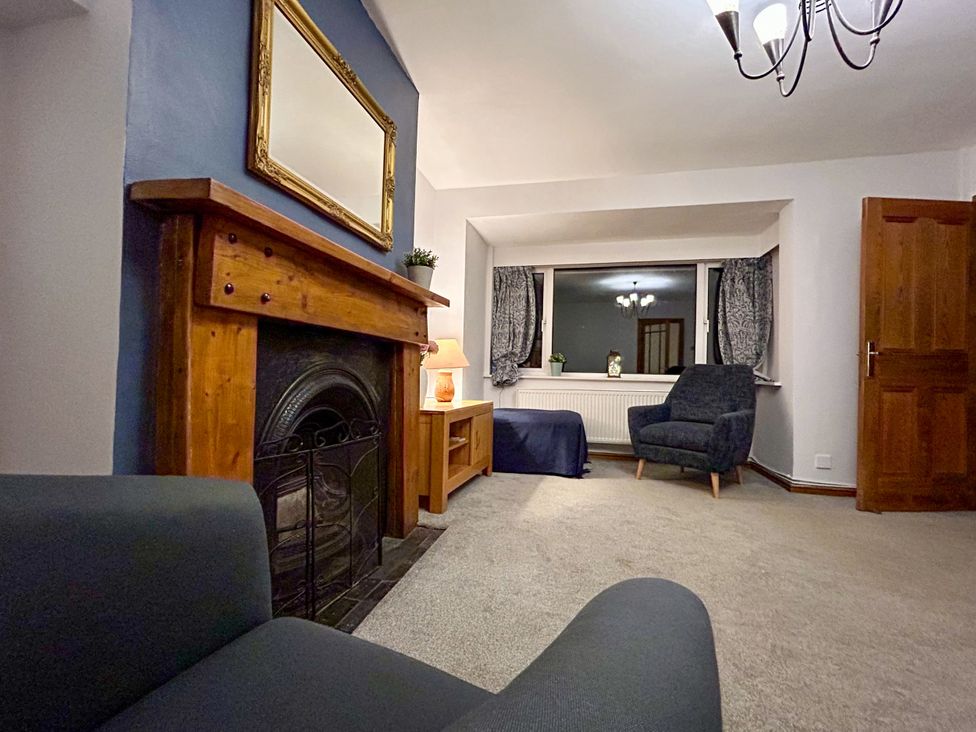 A living room with a fireplace and furniture at Scamnel in Eccleshall