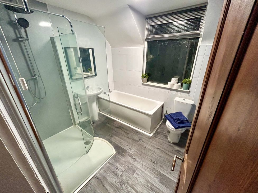 A bathroom with a shower, bathtub, sink, and toilet at Scamnel in Eccleshall