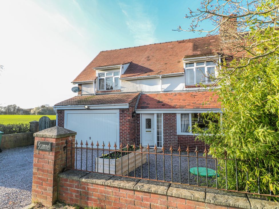 A house with a garage and fence at Scamnel in Eccleshall