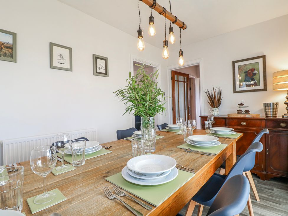 A dining room with a table set for six at Scamnel in Eccleshall
