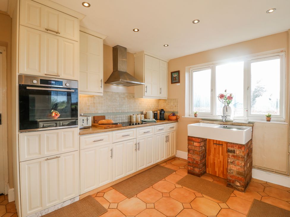 A kitchen featuring cabinets, an oven, a sink and a kettle at Scamnel in Eccleshall
