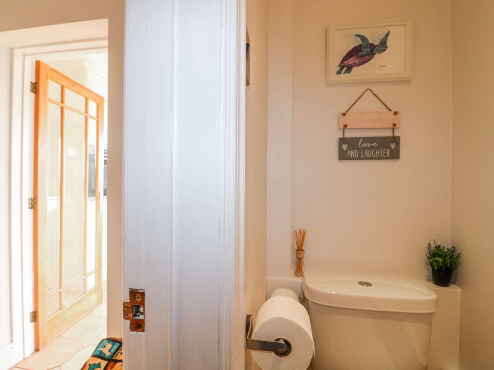 A bathroom with a toilet and decorative signs at Scamnel in Eccleshall