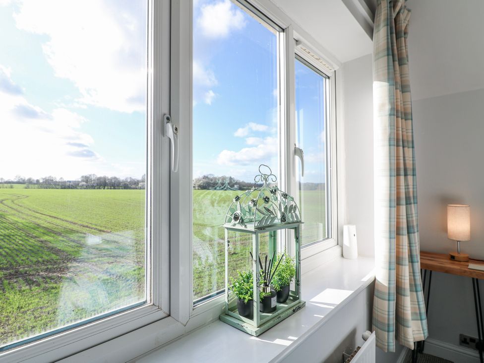 A window with a plant holder and lamp at Scamnel in Eccleshall