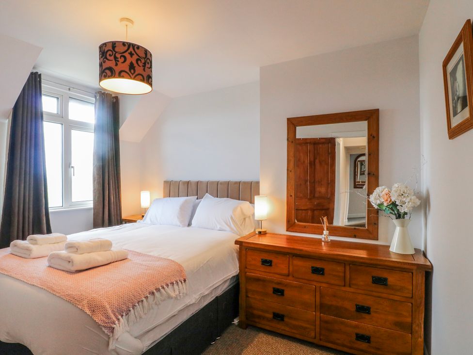 A bedroom with a bed and dresser at Scamnel in Eccleshall