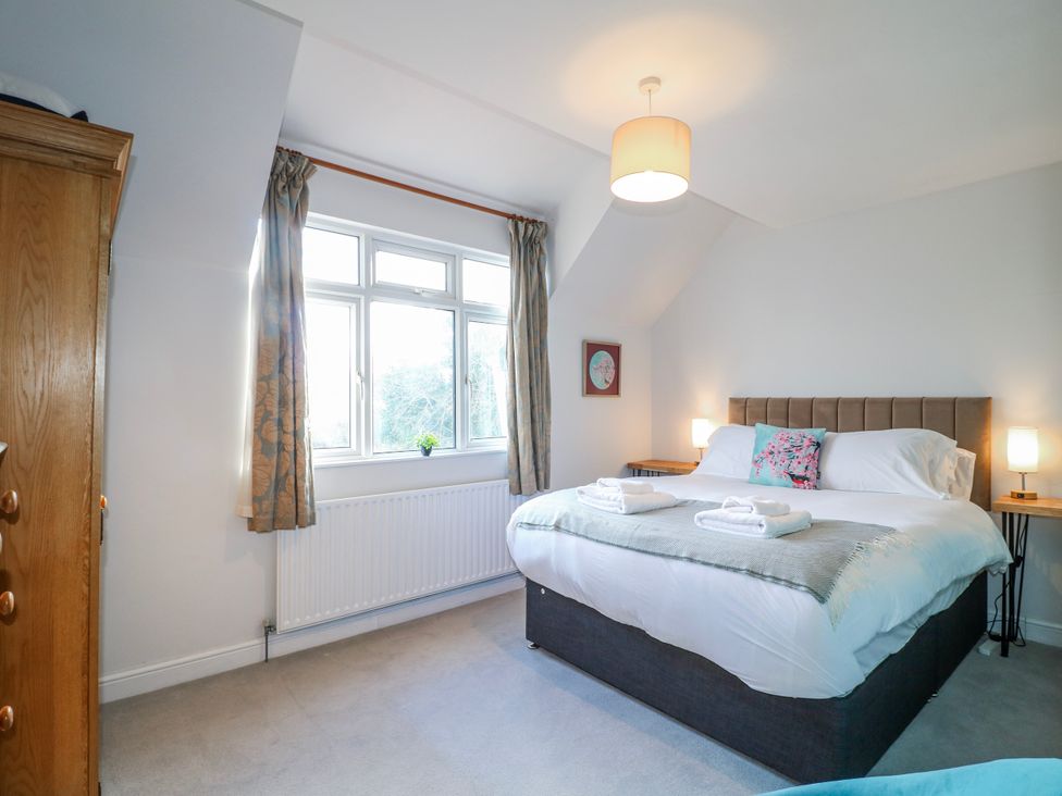 A bedroom with a double bed and window at Scamnel in Eccleshall
