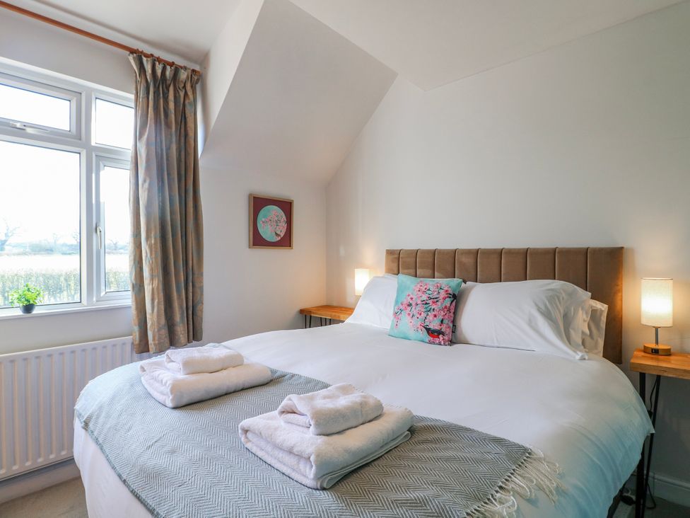 A bedroom with a double bed and window at Scamnel in Eccleshall
