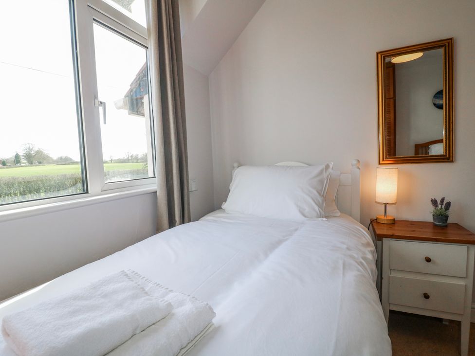 A bedroom with a bed and window at Scamnel, Eccleshall