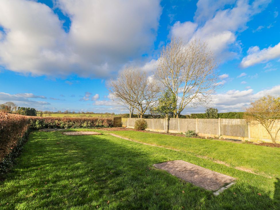 A garden with trees and a fence at Scamnel Eccleshall