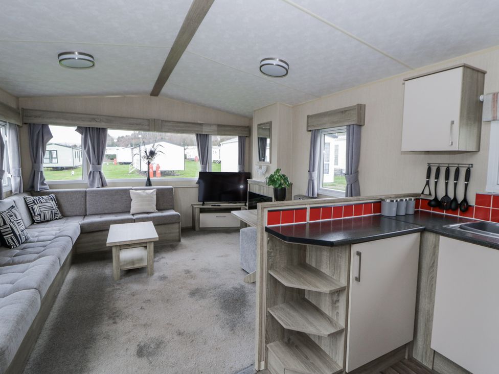 A living room with a sofa and television at Brynowen Holiday Park - Holiday Accommodation 22432 Borth