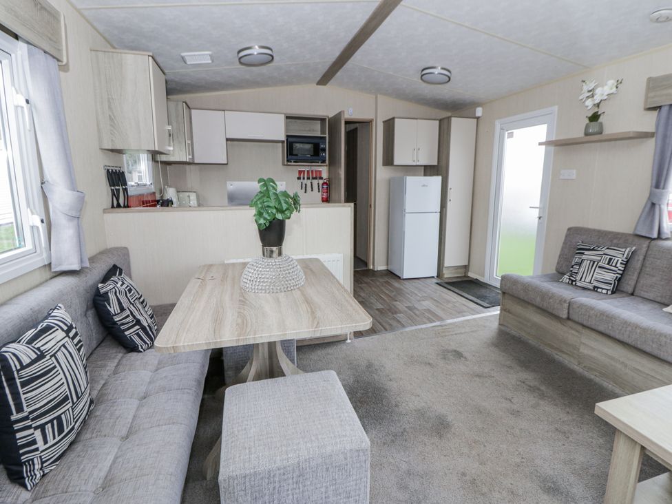 A living room with a sofa and coffee table at Brynowen Holiday Park - Holiday Accommodation 22432 Borth