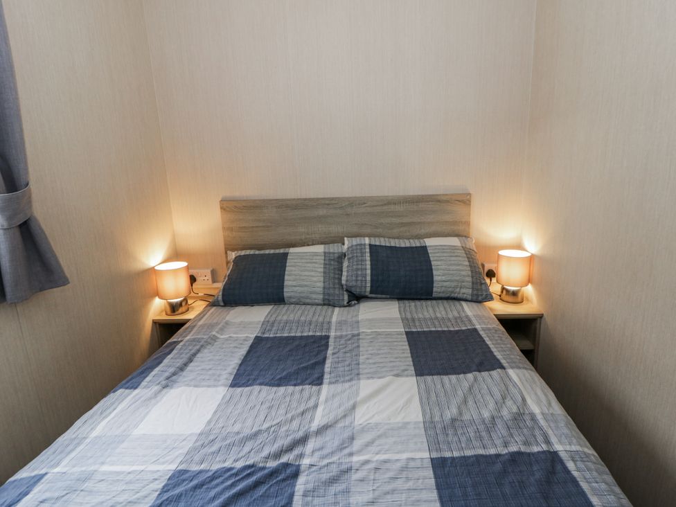 A bedroom with a bed and lamps at Brynowen Holiday Park - Holiday Accommodation 22432, Borth
