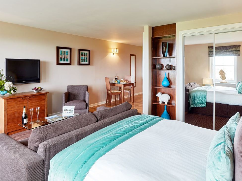 A living room with a sofa and television at Ullswater Apartment in Penrith