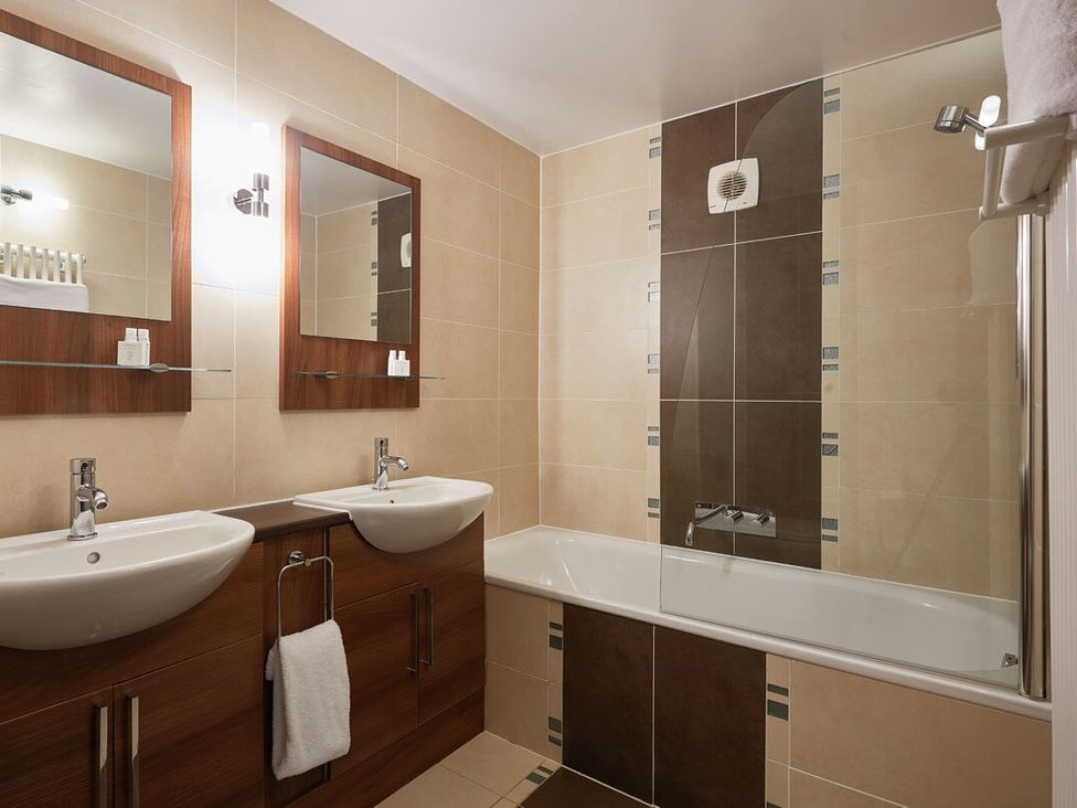 A bathroom with sinks and mirrors at Ullswater Apartment in Penrith