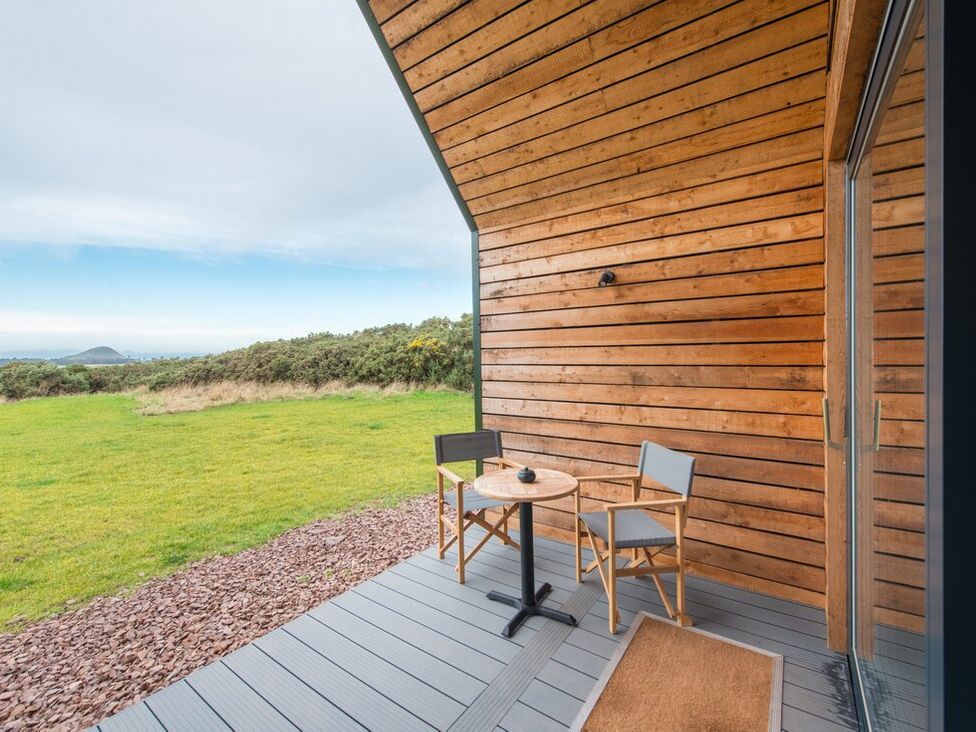 An outdoor patio with a table and chairs at The Weir in North Berwick