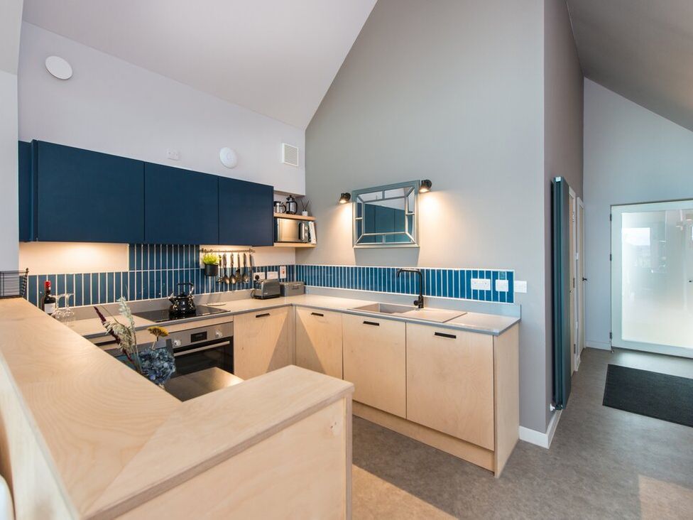 A kitchen with cabinets and a sink at The Weir in North Berwick