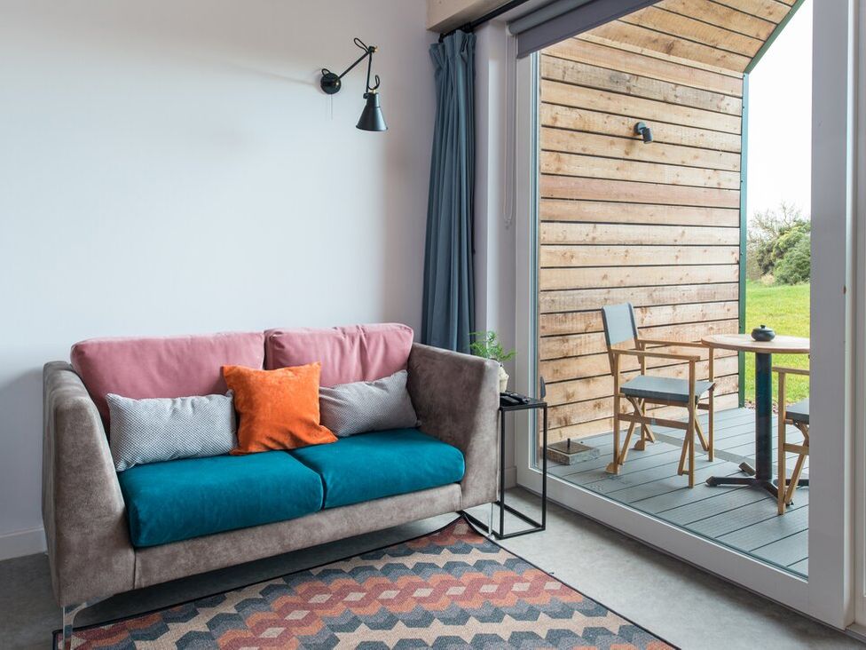 A living room with a sofa and table at The Weir in North Berwick