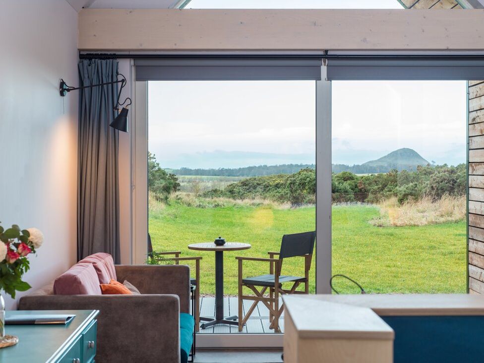 A living room with a view of a table and chairs at The Weir in North Berwick