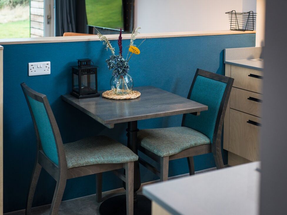 A dining area with a table and chairs at The Weir in North Berwick