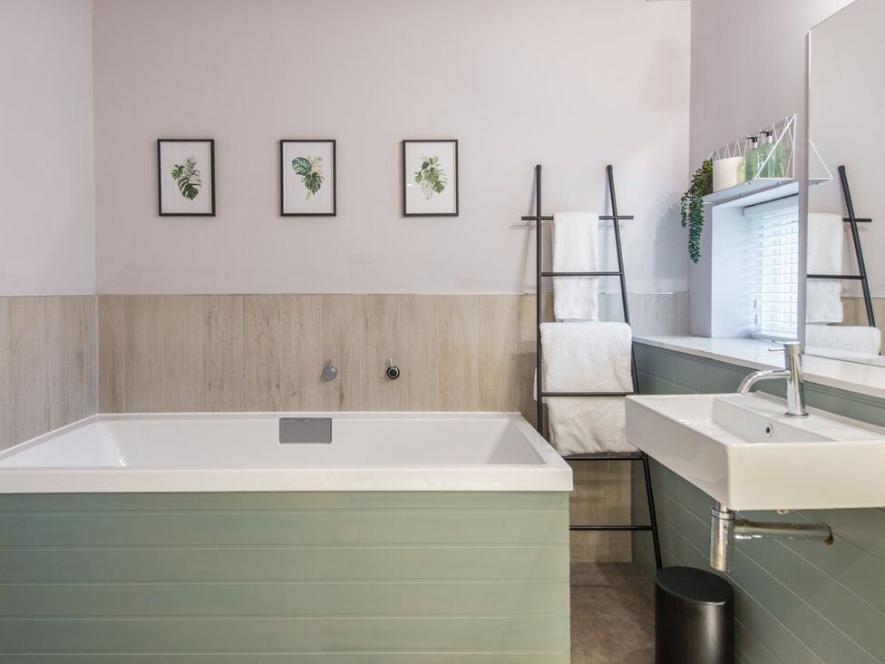 A bathroom with a bathtub and sink at The Weir in North Berwick