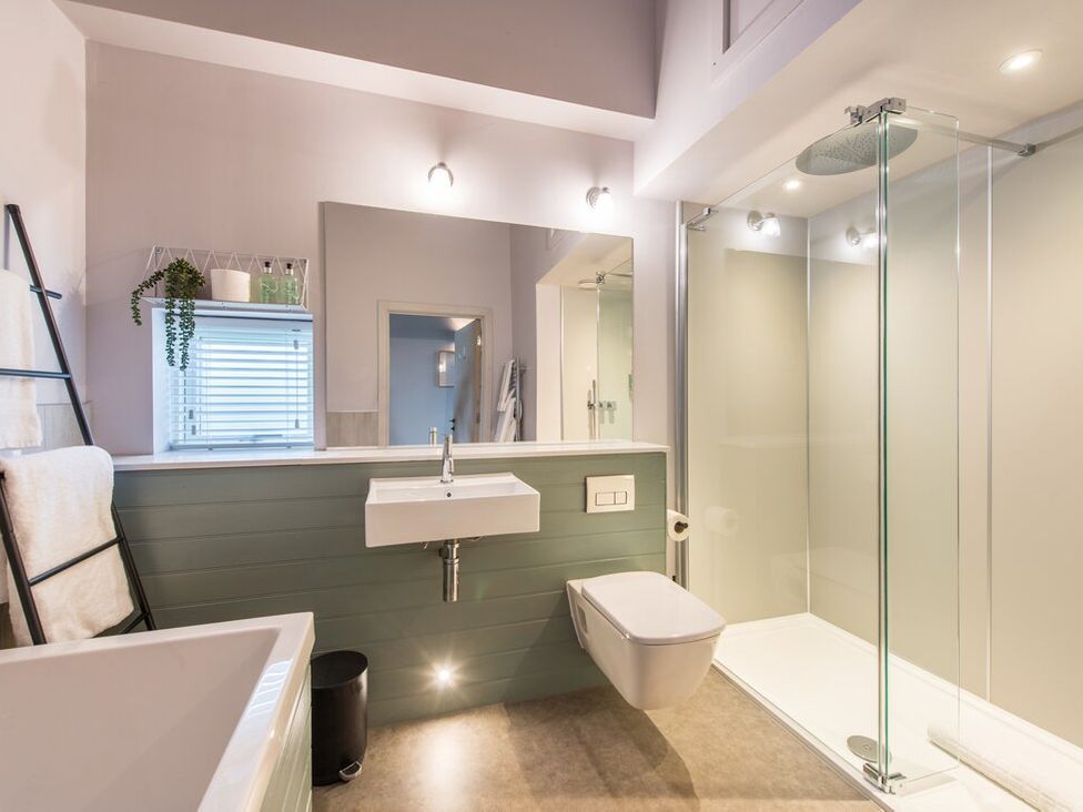 A bathroom with a bathtub, sink, toilet, and shower at The Weir in North Berwick