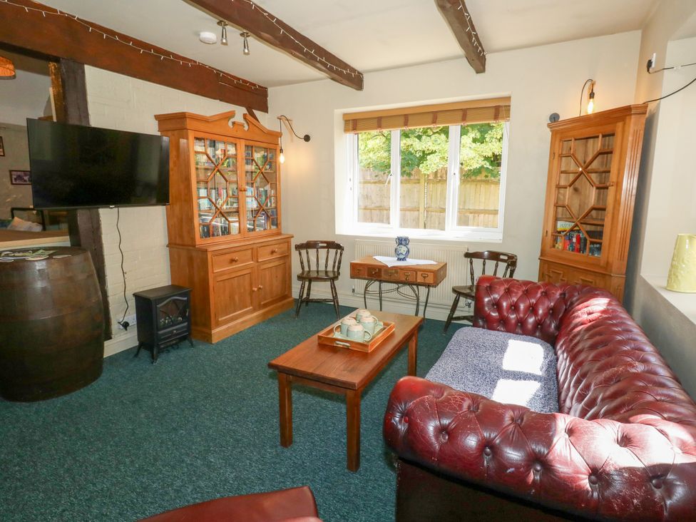 A living room with a sofa and coffee table at The Old Barn in Stourton Caundle near Stalbridge