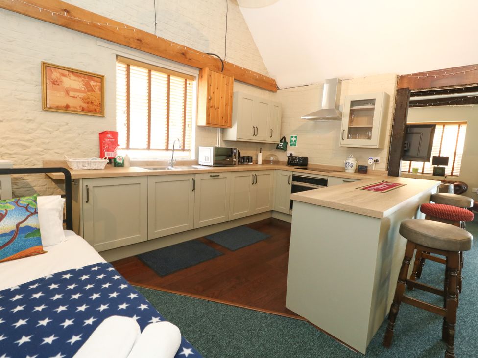 A kitchen with cabinets and a sink at The Old Barn in Stourton Caundle near Stalbridge