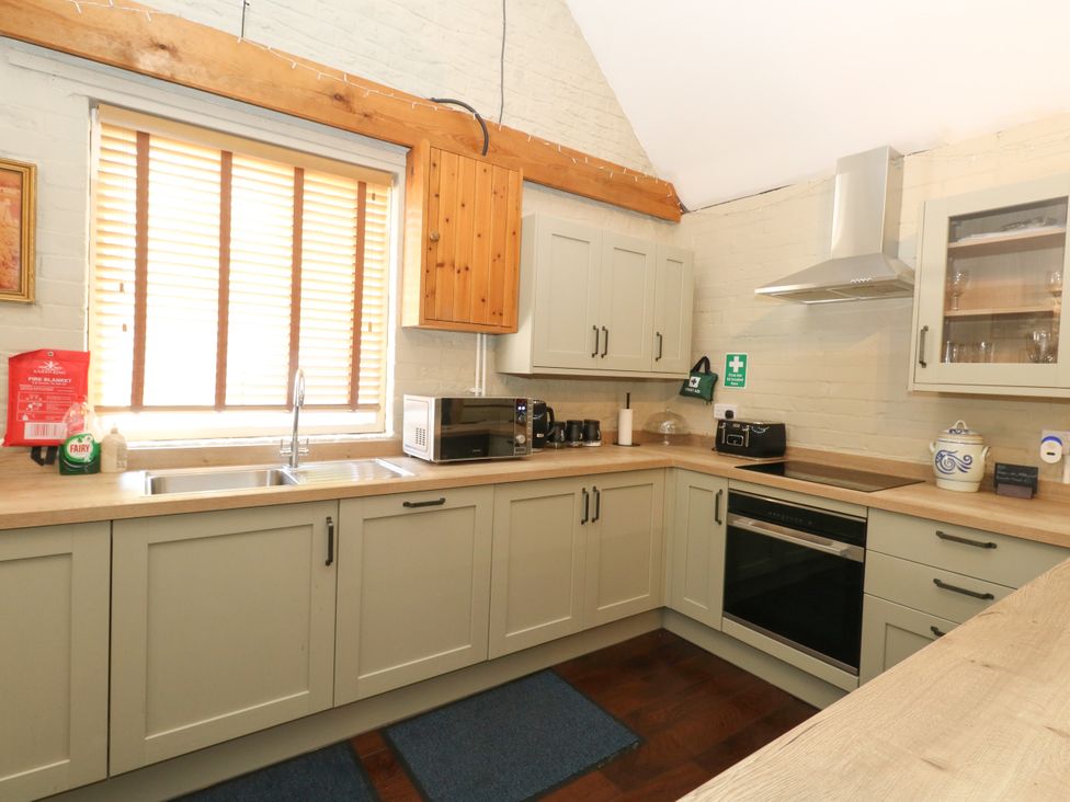 A kitchen with a sink and appliances at The Old Barn in Stourton Caundle near Stalbridge