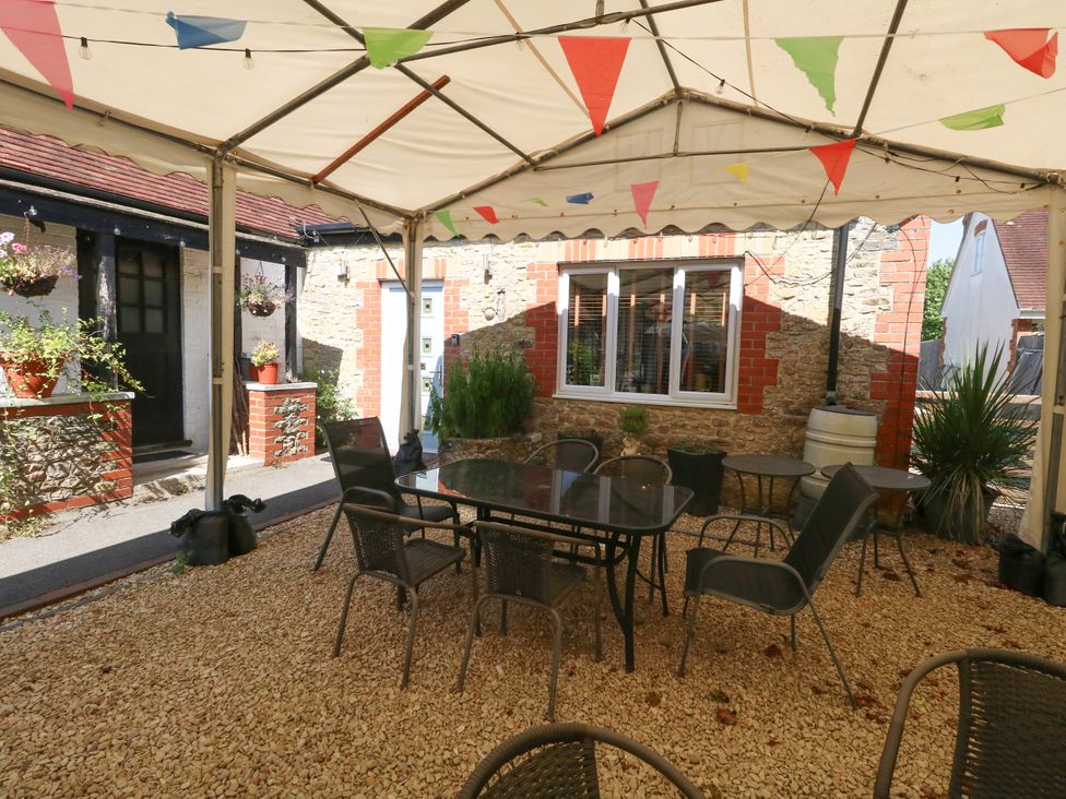 An outdoor seating area with a canopy at The Old Barn in Stourton Caundle near Stalbridge