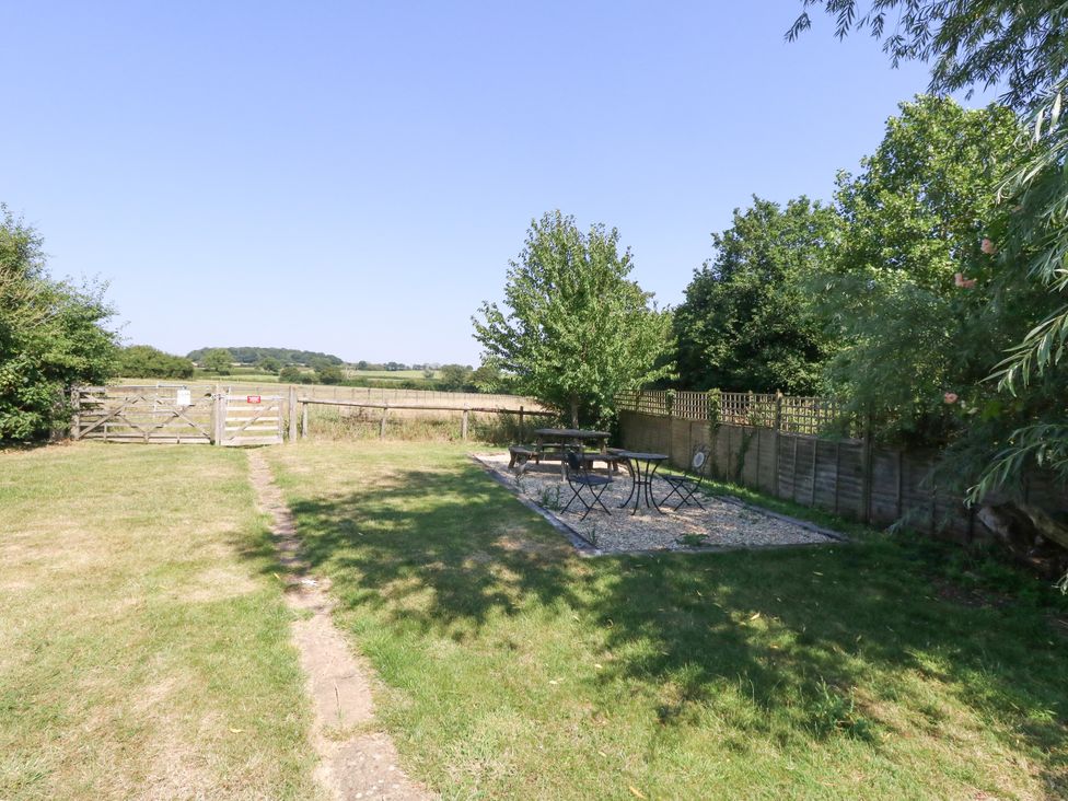 A garden with table and chairs at The Old Barn in Stourton Caundle near Stalbridge