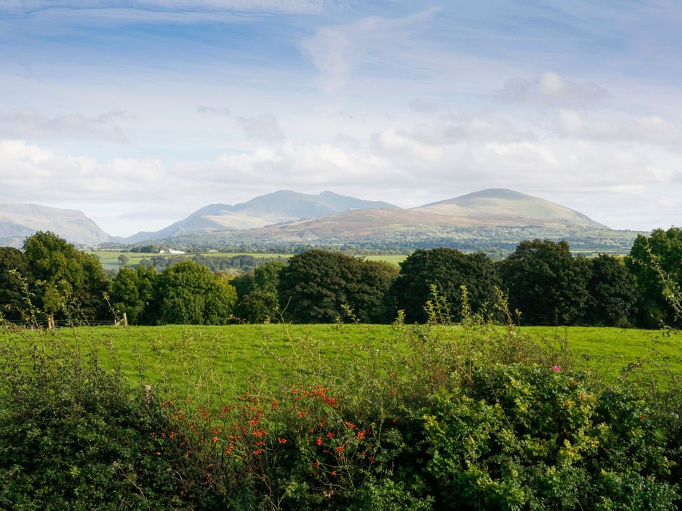 A view of mountains and trees in the landscape at Trigfa in Brynsiencyn near Llanfairpwllgwyngyll